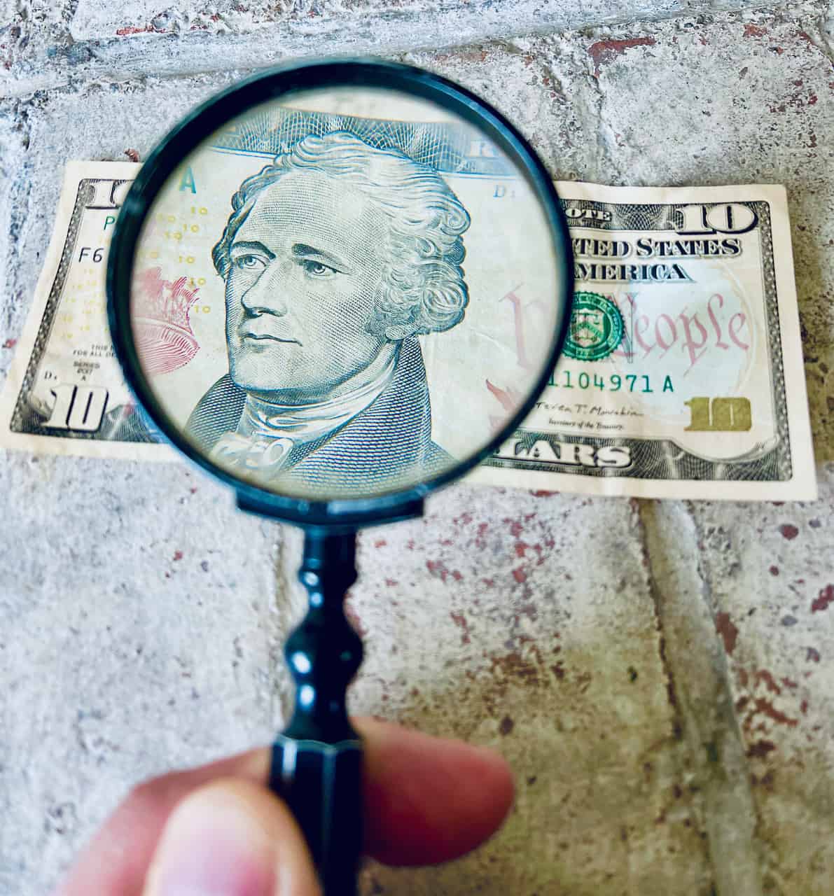 Magnifying glass over a dollar bill
